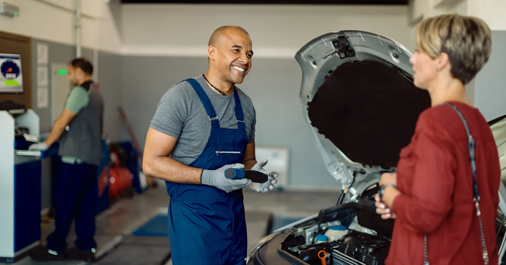 auto-repairman-talking-customer-workshop copy